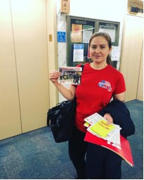 Photo Caption: Business Agent Sam Rider (Photo: Mar 3 Lobby Day 2) passes out postcards handwritten by graduate students expressing the financial struggles they find themselves in due to fees. 